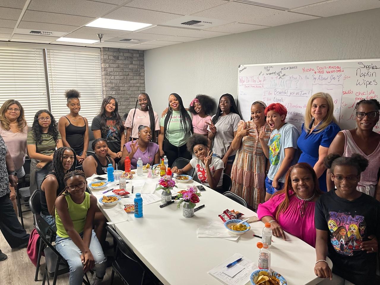Youth and mentors gathered around a workshop table